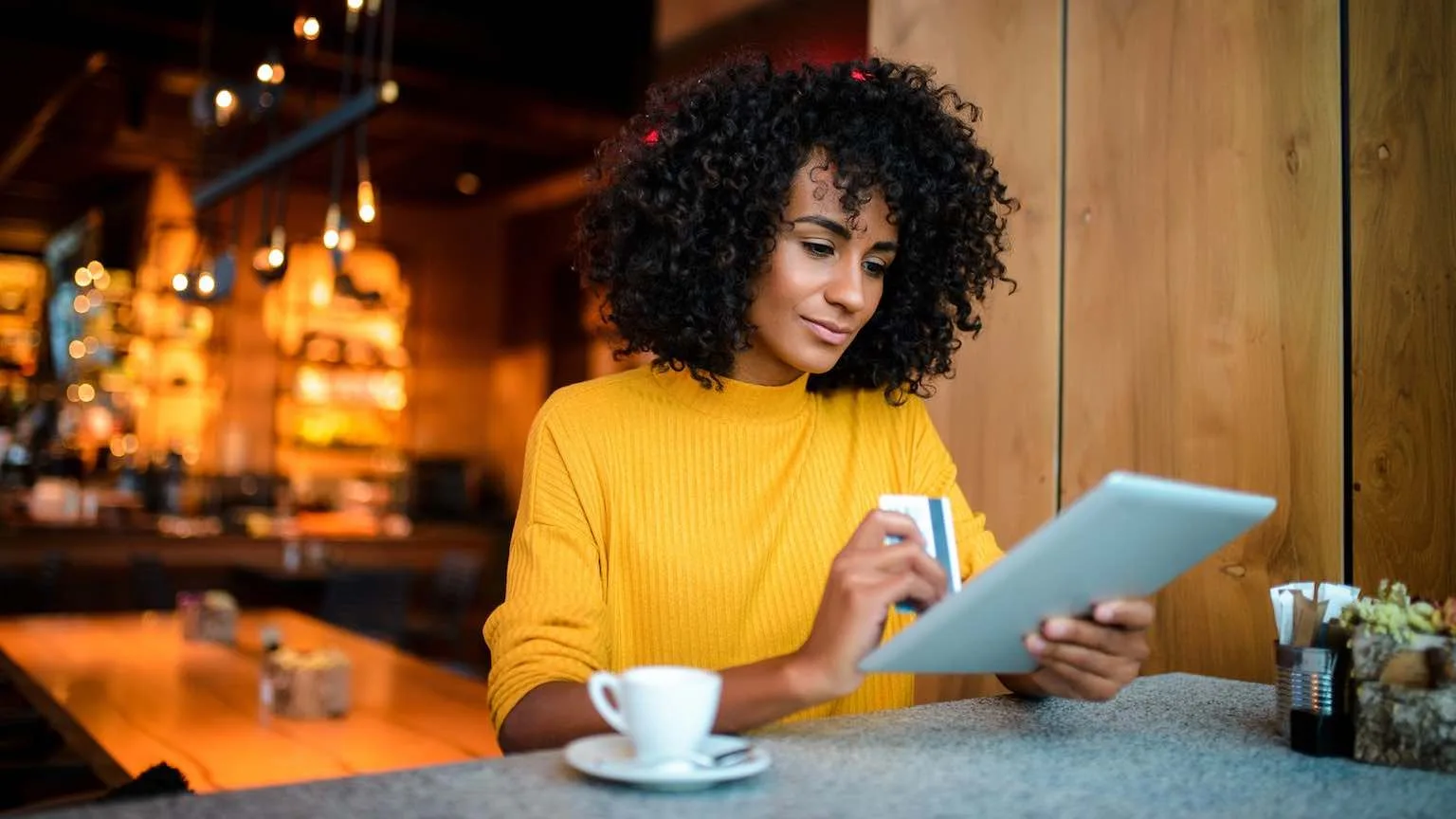 Image: Getty Images Lady using credit card to shop online using tablet.