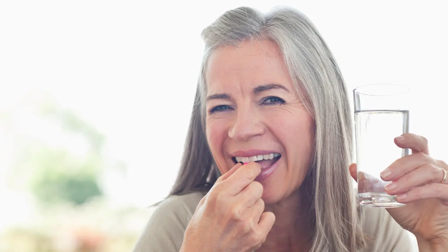 Image: Getty Images woman drinking meds
