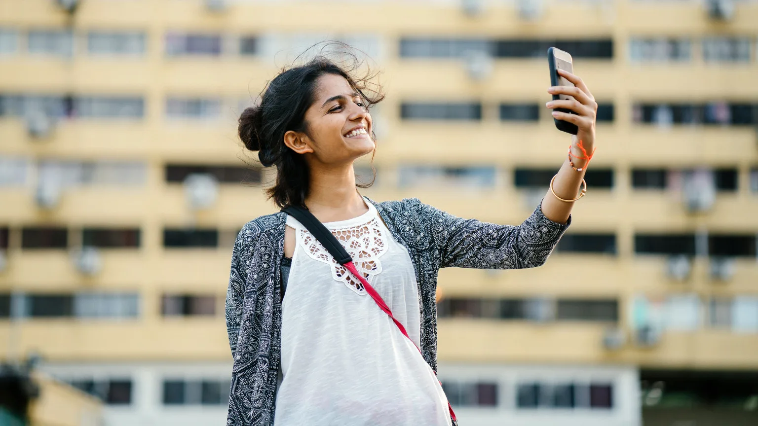 Pexels Woman holding phone with camera