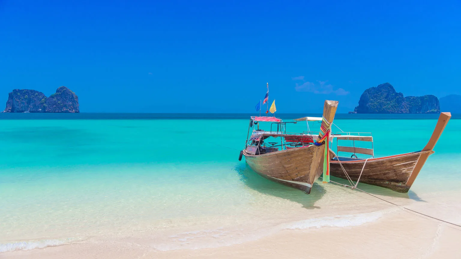 Image: Getty Images Two long tailed boats parking on the beautiful beach at Koh Hai, Trang province, Thailand.