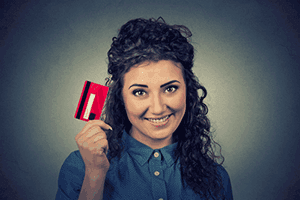 woman-holding-up-credit-card-owner