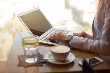 Woman on laptop at cafe