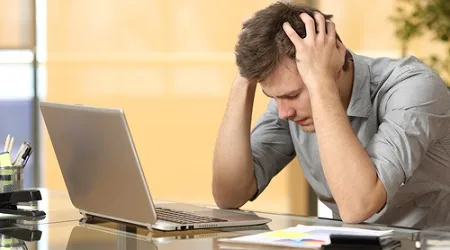 angry frustrated man computer desk office hands on head angry frustrated man computer desk office hands on head