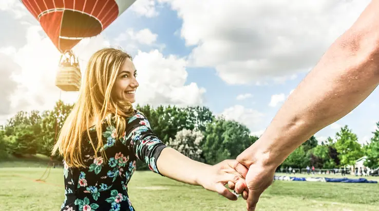 Couple standing in front of hotair balloon