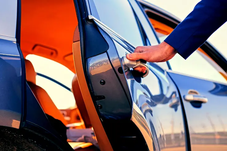 driver opening private limousine