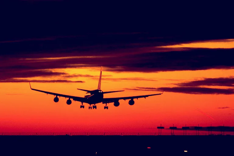 plane landing at sunset