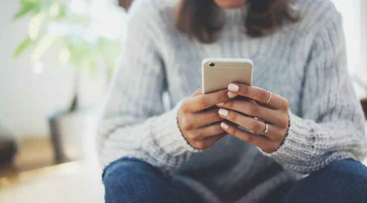 woman's hands using an iPhone