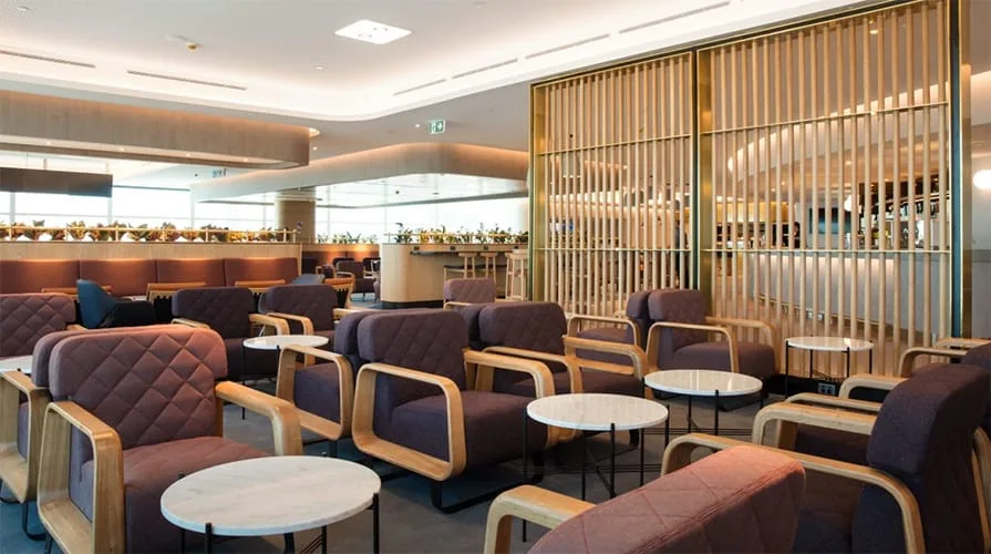 Qantas lounge with plum coloured seats