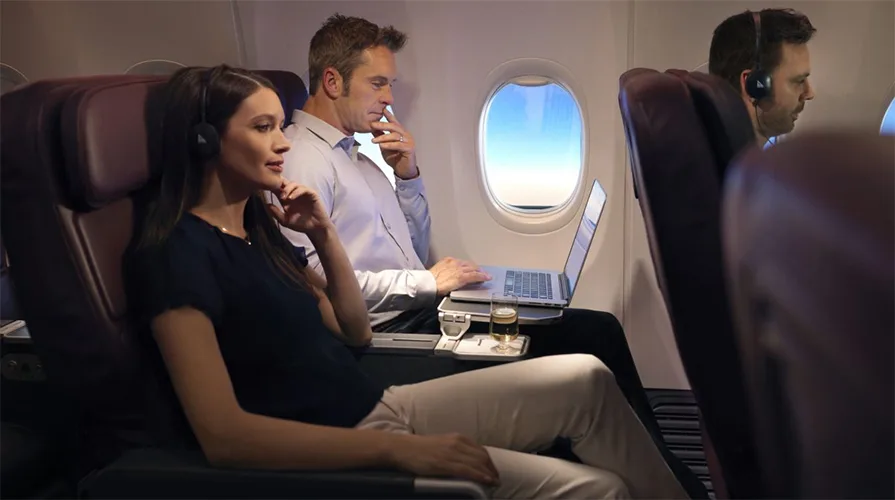 man using laptop inflight Qantas