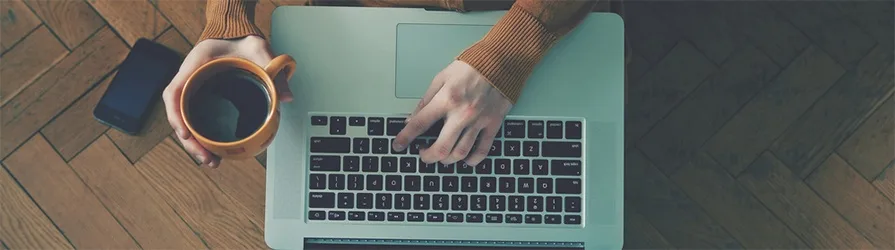 rustic image of hands with laptop and coffee