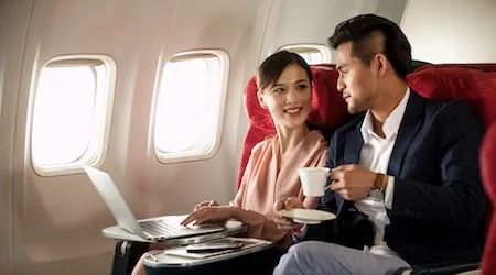 You own a business, so you should fly in business class