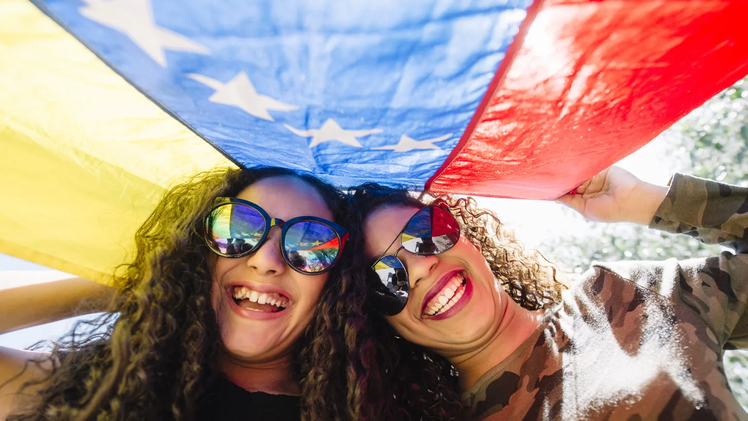 Image: Shutterstock Young girls with flag of Venezuela