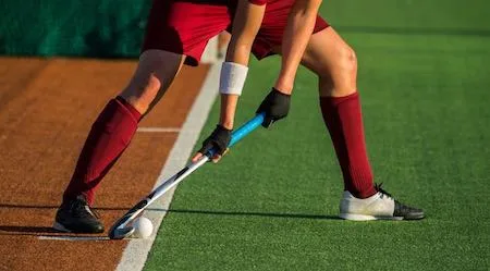 Low Section Of Player Playing Hockey On Field Low Section Of Player Playing Hockey On Field