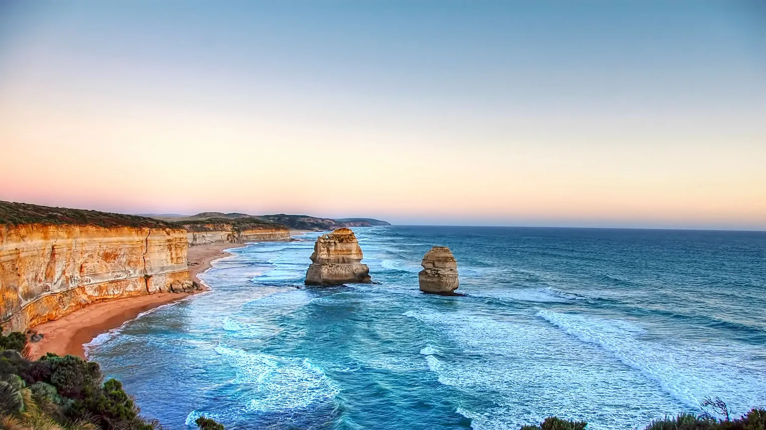 Image: Getty Images Great Ocean Road at dusk