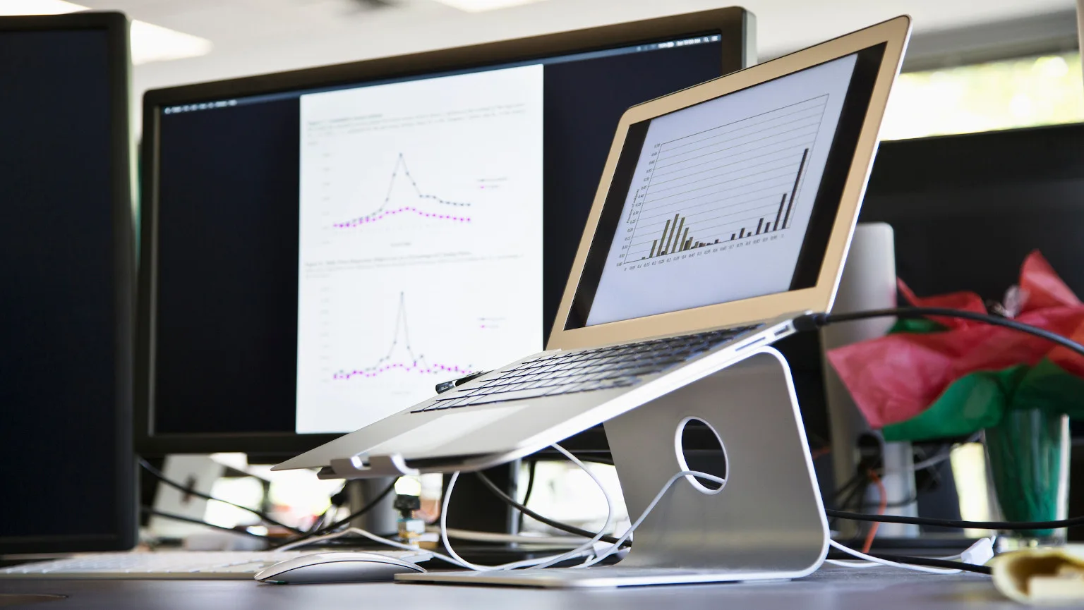 Image: Getty Images Laptop stand on desk with graphs