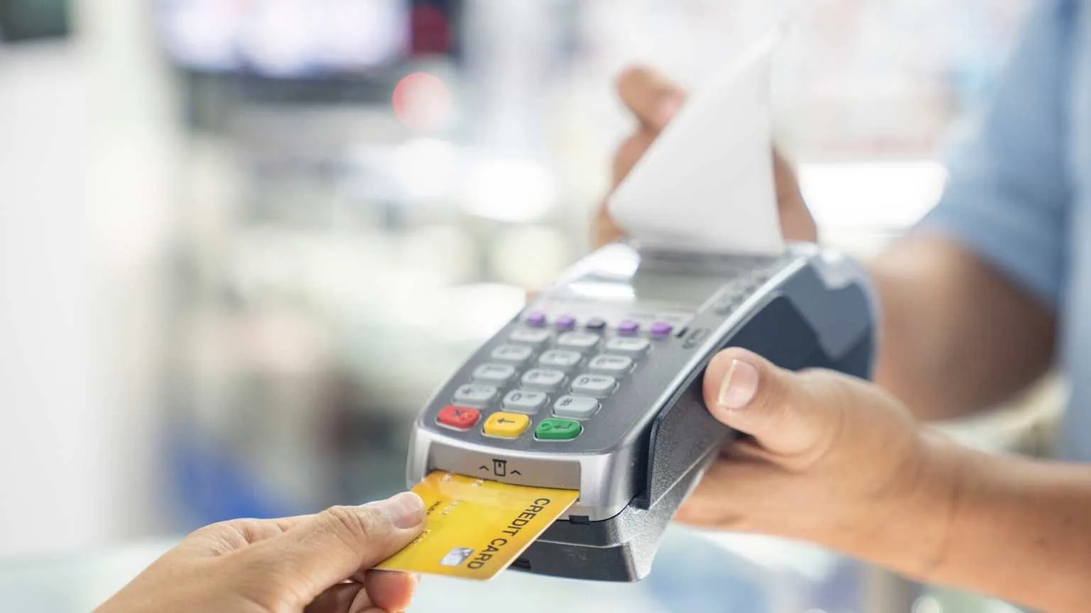 Image: Getty Images Man making a credit card purchase