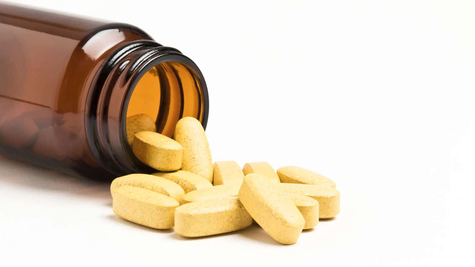 Image: Getty Images Vitamins spilling our of a bottle