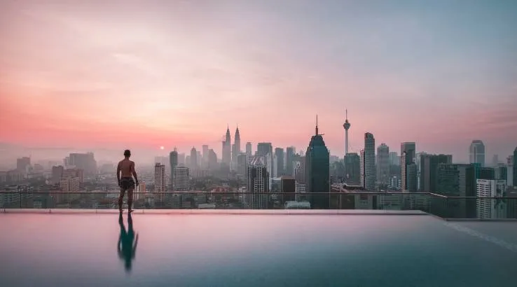 Man Looking At Kuala Lumpur Cityscape