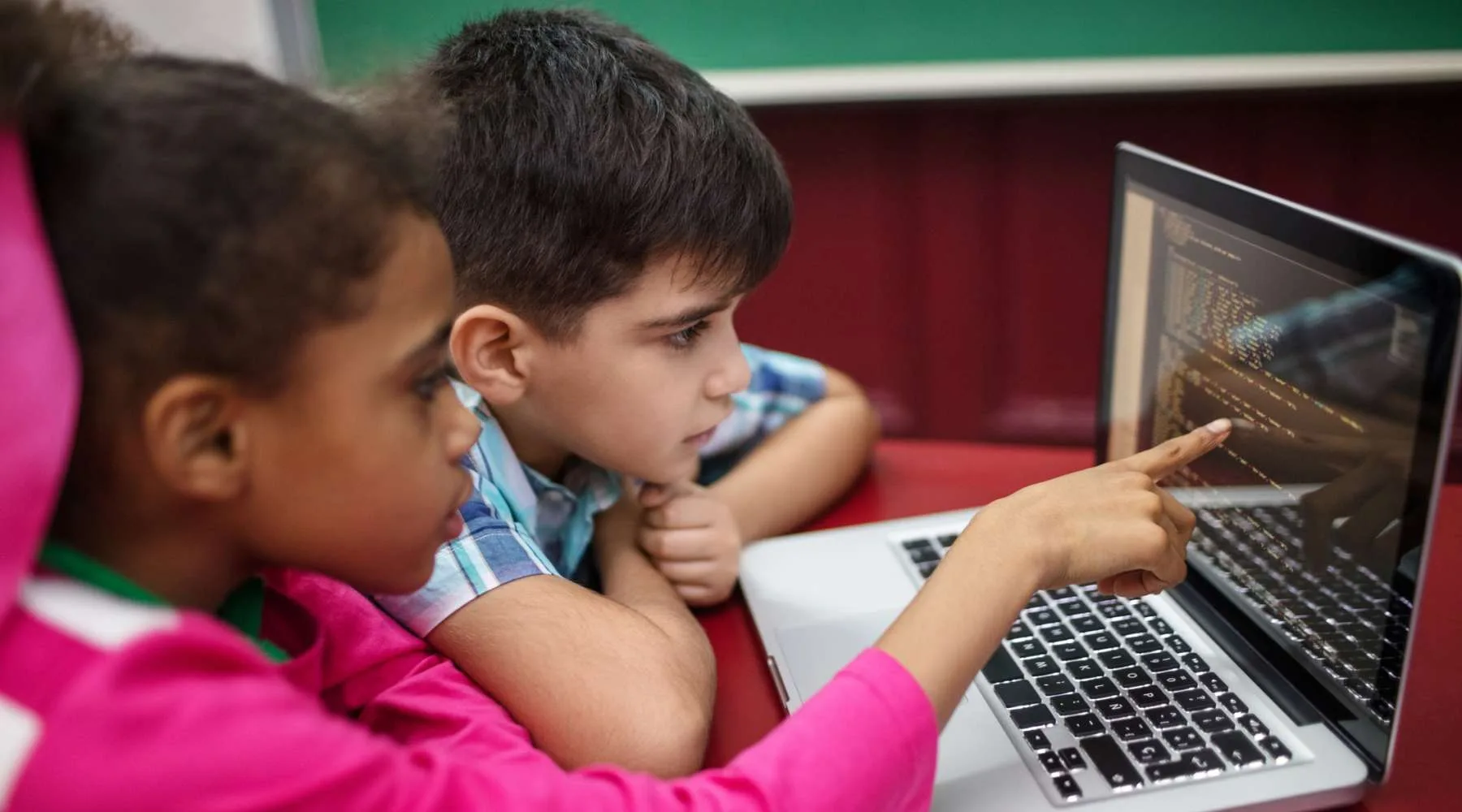 Students creating programs while using laptop Students creating programs while using laptop
