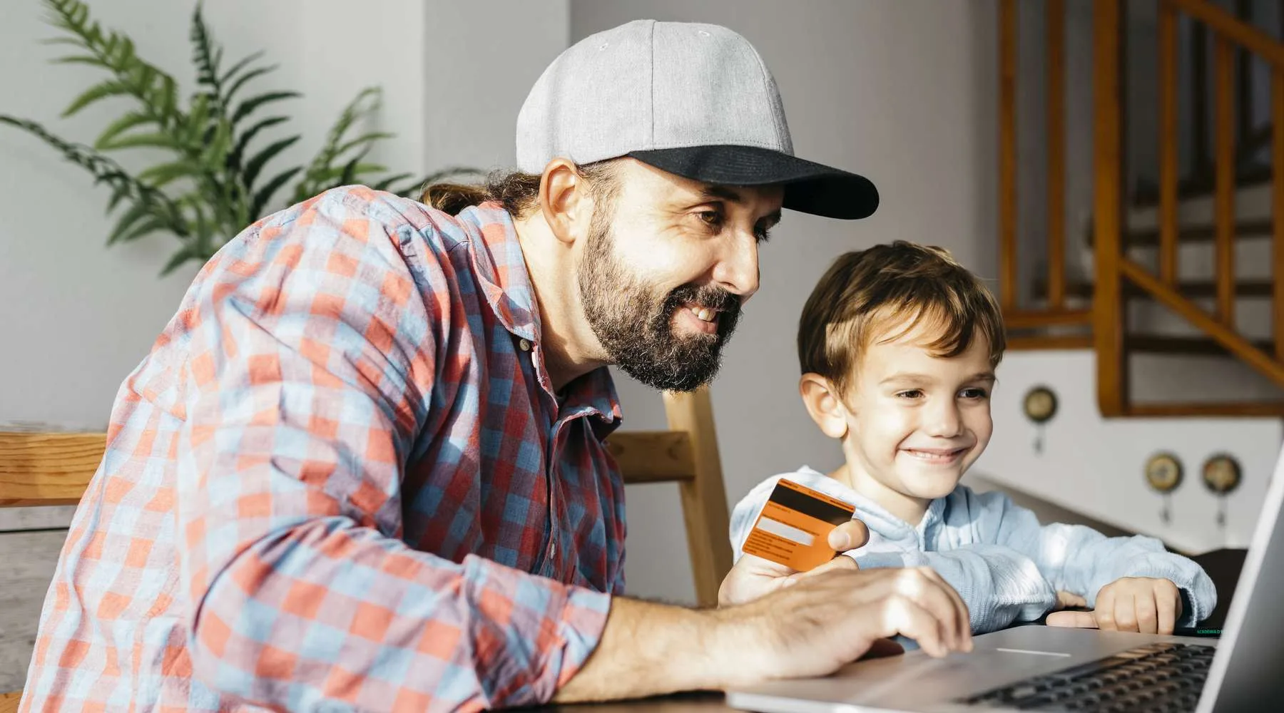 Father and son using laptop together, online shopping Father and son using laptop together, online shopping