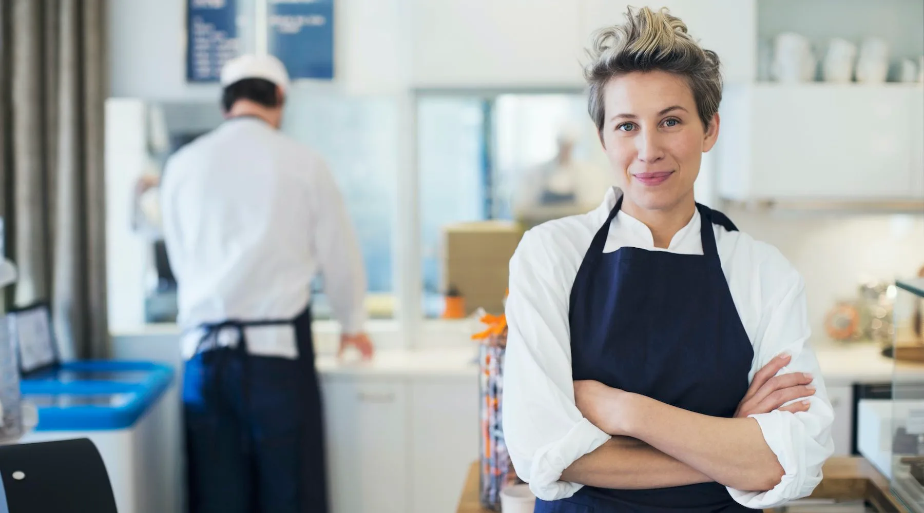 Portrait of confident female owner standing arms crossed in cafe Portrait of confident female owner standing arms crossed in cafe
