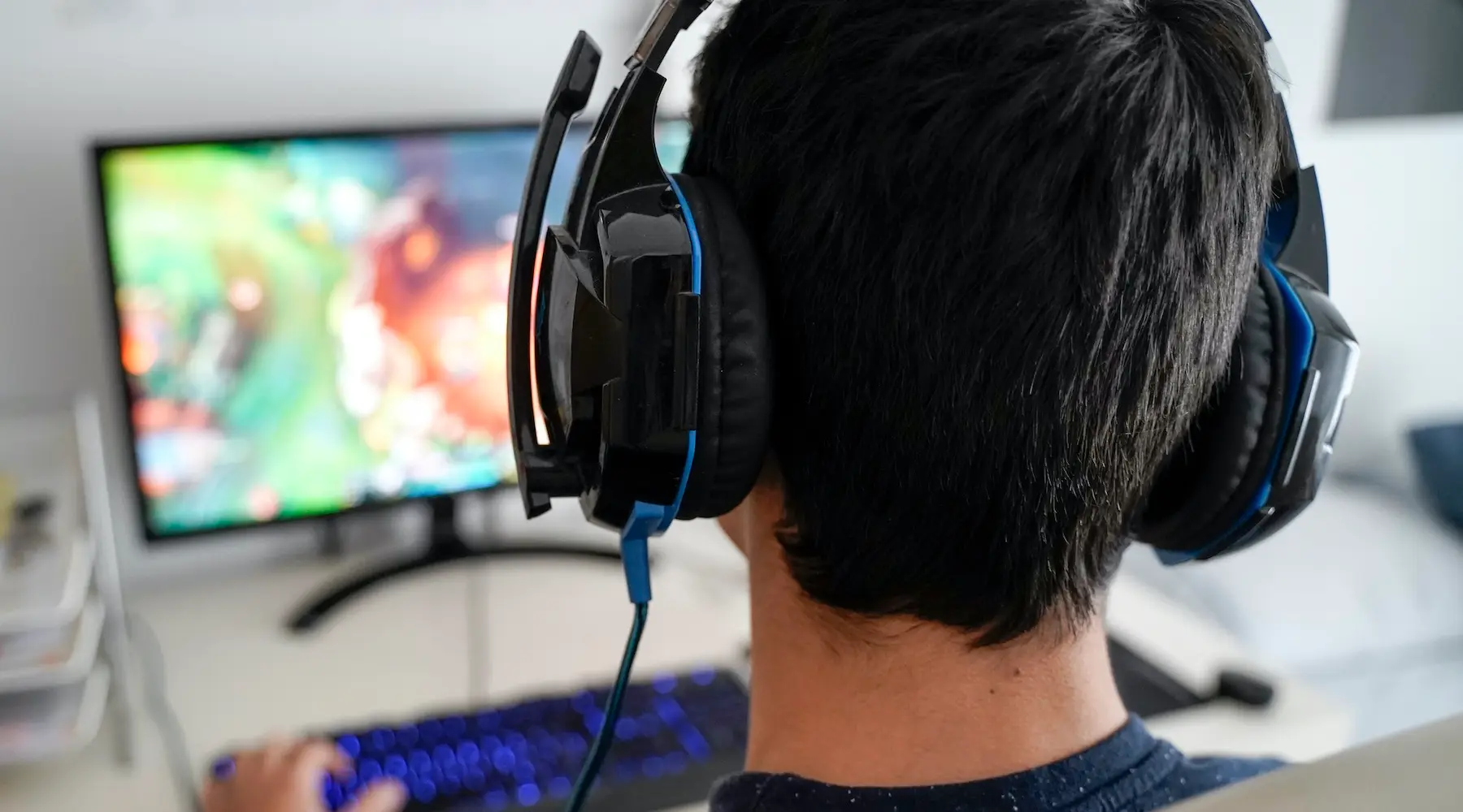 Boy with headphones playing on his computer Boy with headphones playing on his computer