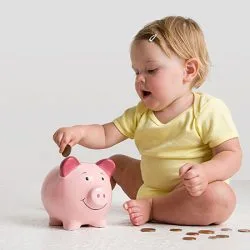 Image: Getty Images Baby saving money in a piggy bank