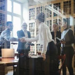Image: Getty Images Buyer and seller meeting with lawyers