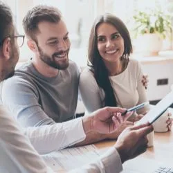 Image: Shutterstock Couple signing mortgage