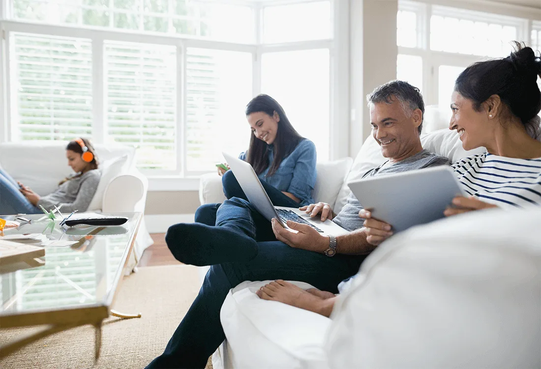 Image: Getty Images Family hanging out at their living room while using wireless tech
