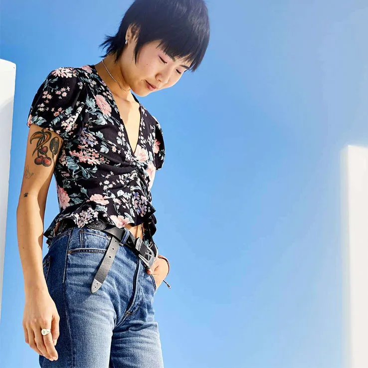 Asian female woman with floral shirt and blue jeans