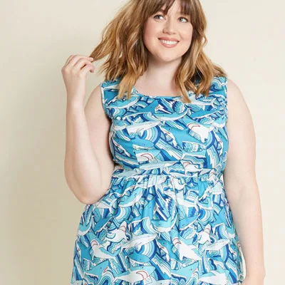 Blonde curvy girl wearing blue dress