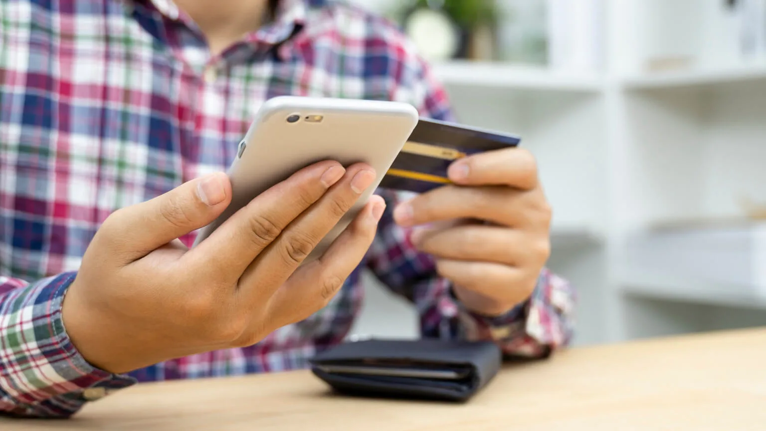 Image: Getty Images person looking at their credit card because of fraud