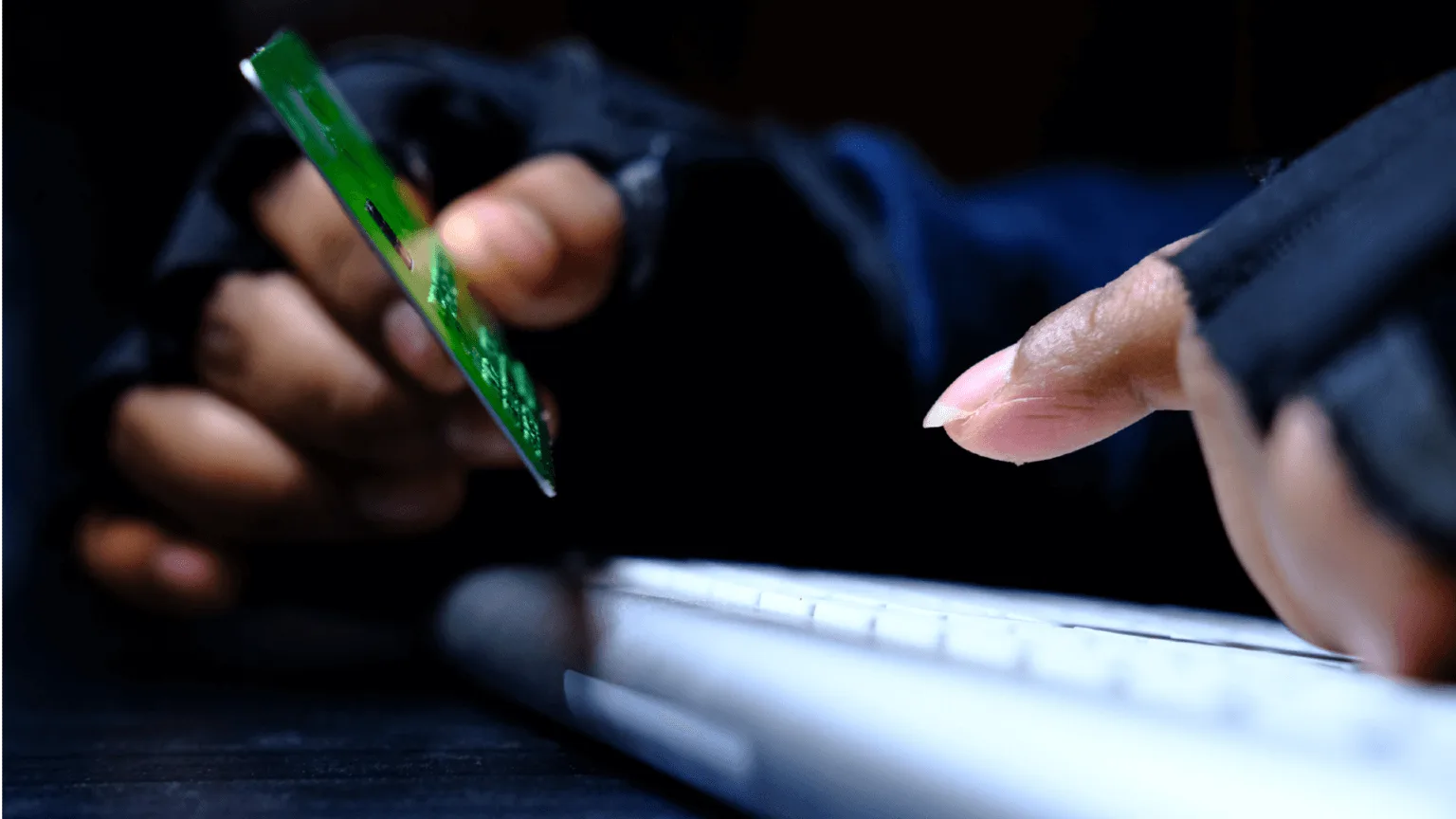 Image: Getty Images A person stealing credit card information on a computer