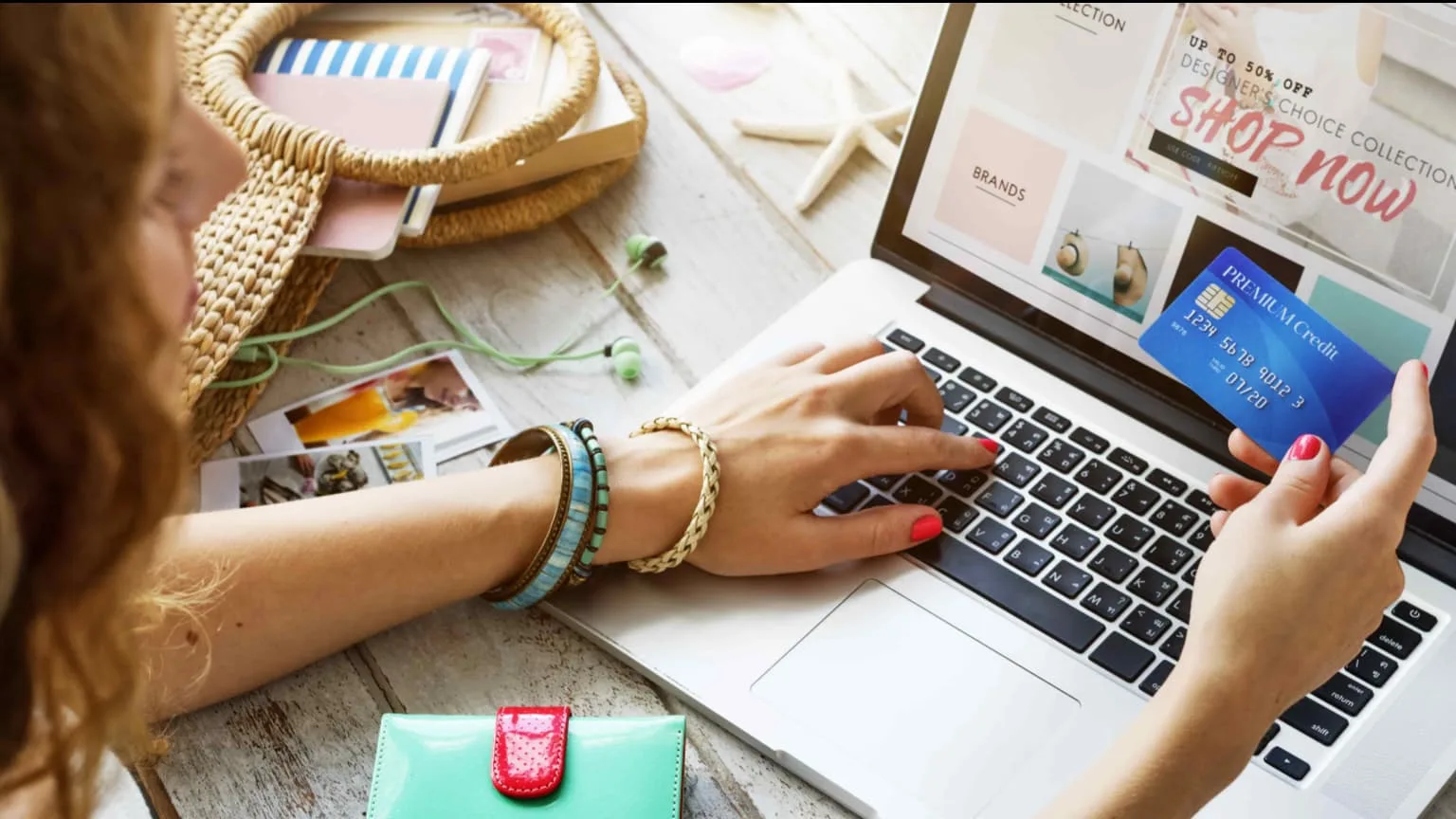 Image: Shutterstock A woman shopping online with a credit card in hand