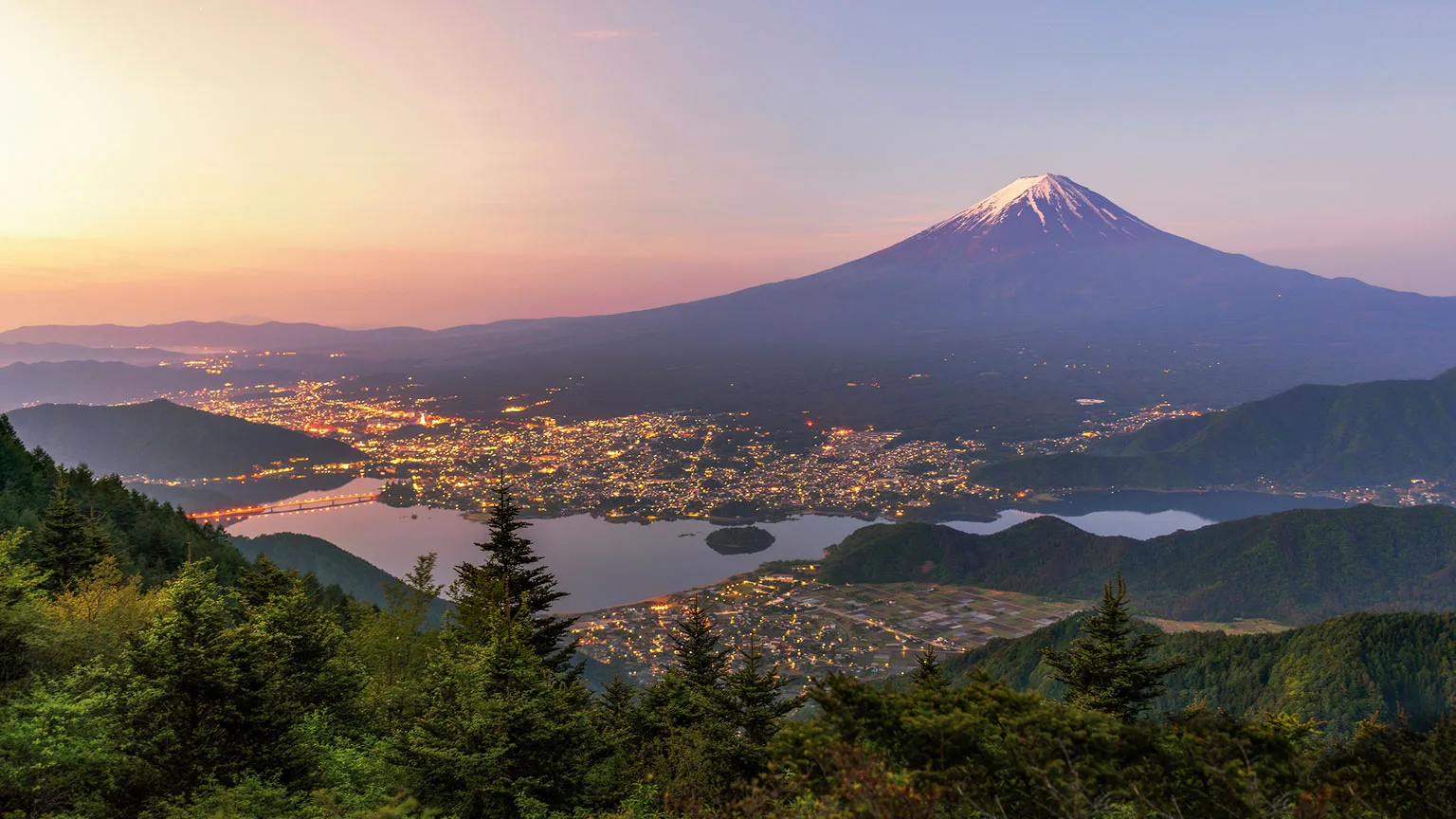 Image: Getty Images Mount Fuji above Tokyo, Japan at sunset