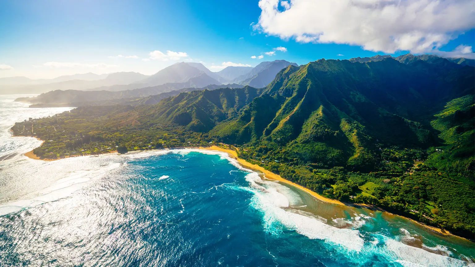 Image: Getty Images Aerial view of green Hawaiian island with blue sea in bright sun
