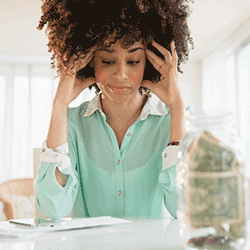 Image: Getty Images Stressed woman, paying bills