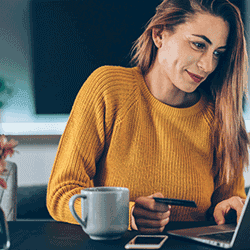 Image: Getty Images Woman paying online with credit card