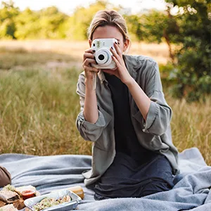 Woman taking a photo with instant camera