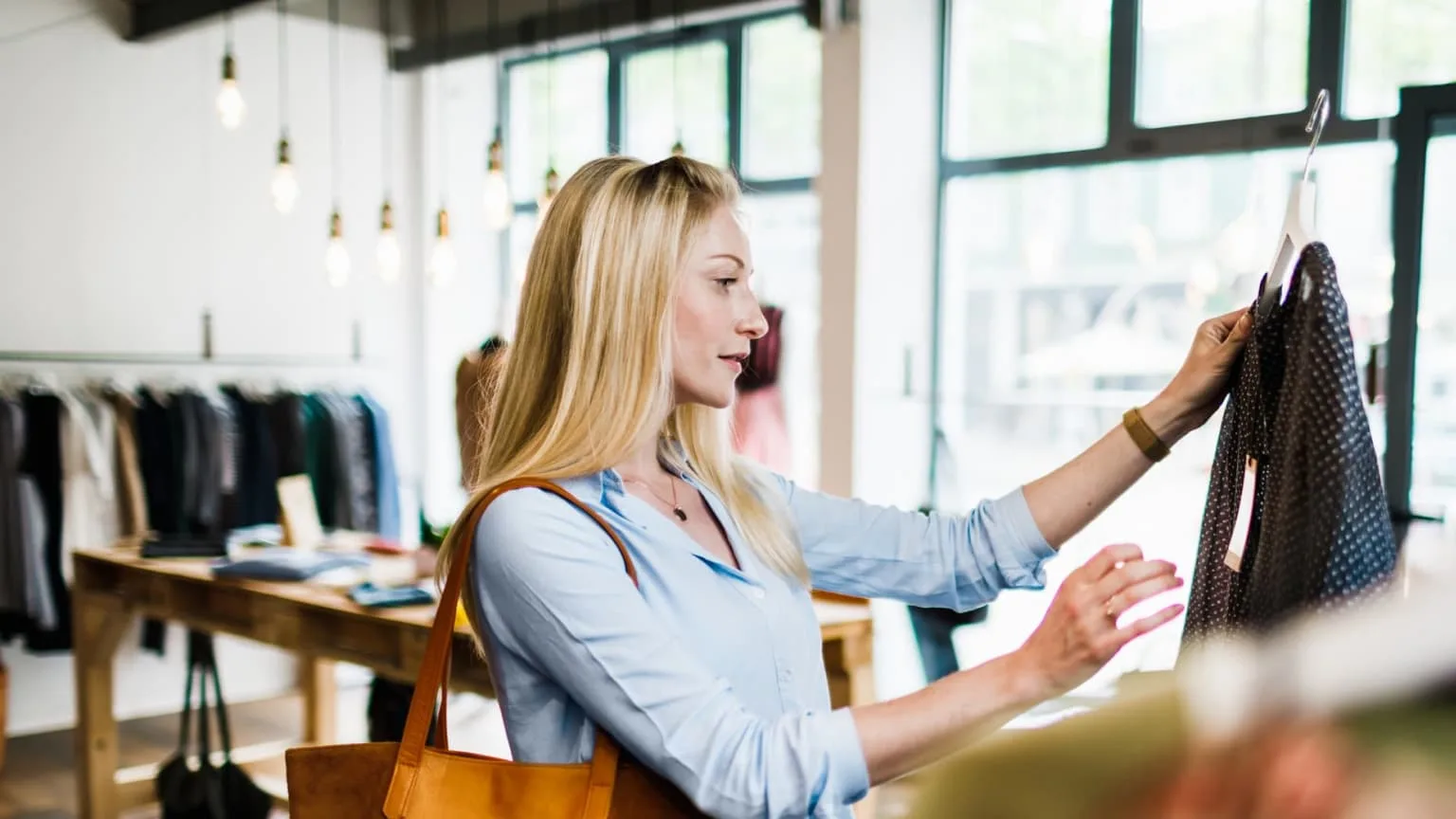 Image: Getty Images woman checking on label while shopping