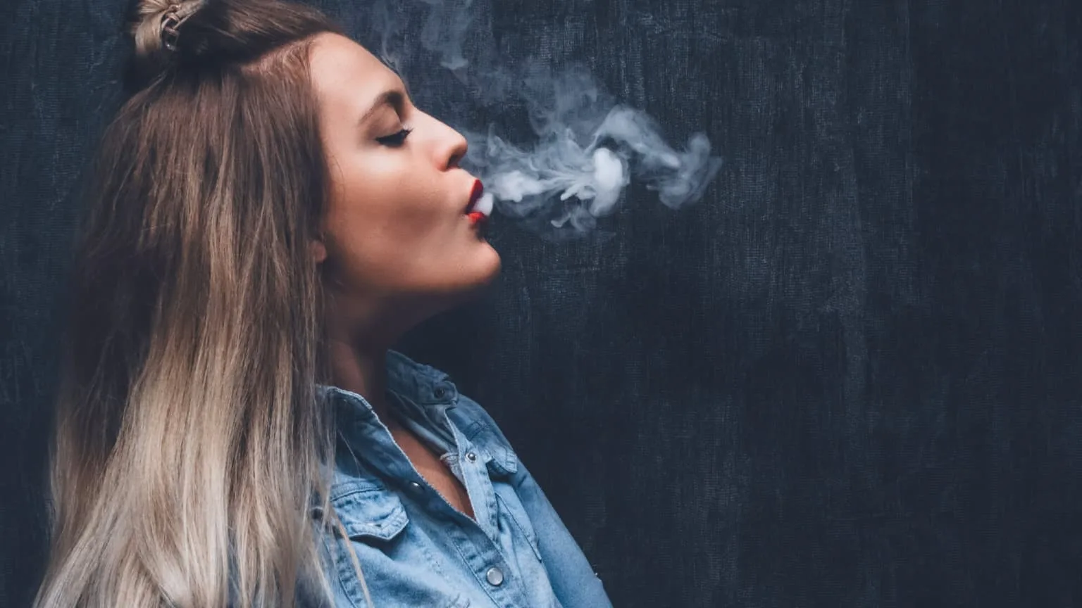 Image: Shutterstock Woman with smoke coming out of her mouth