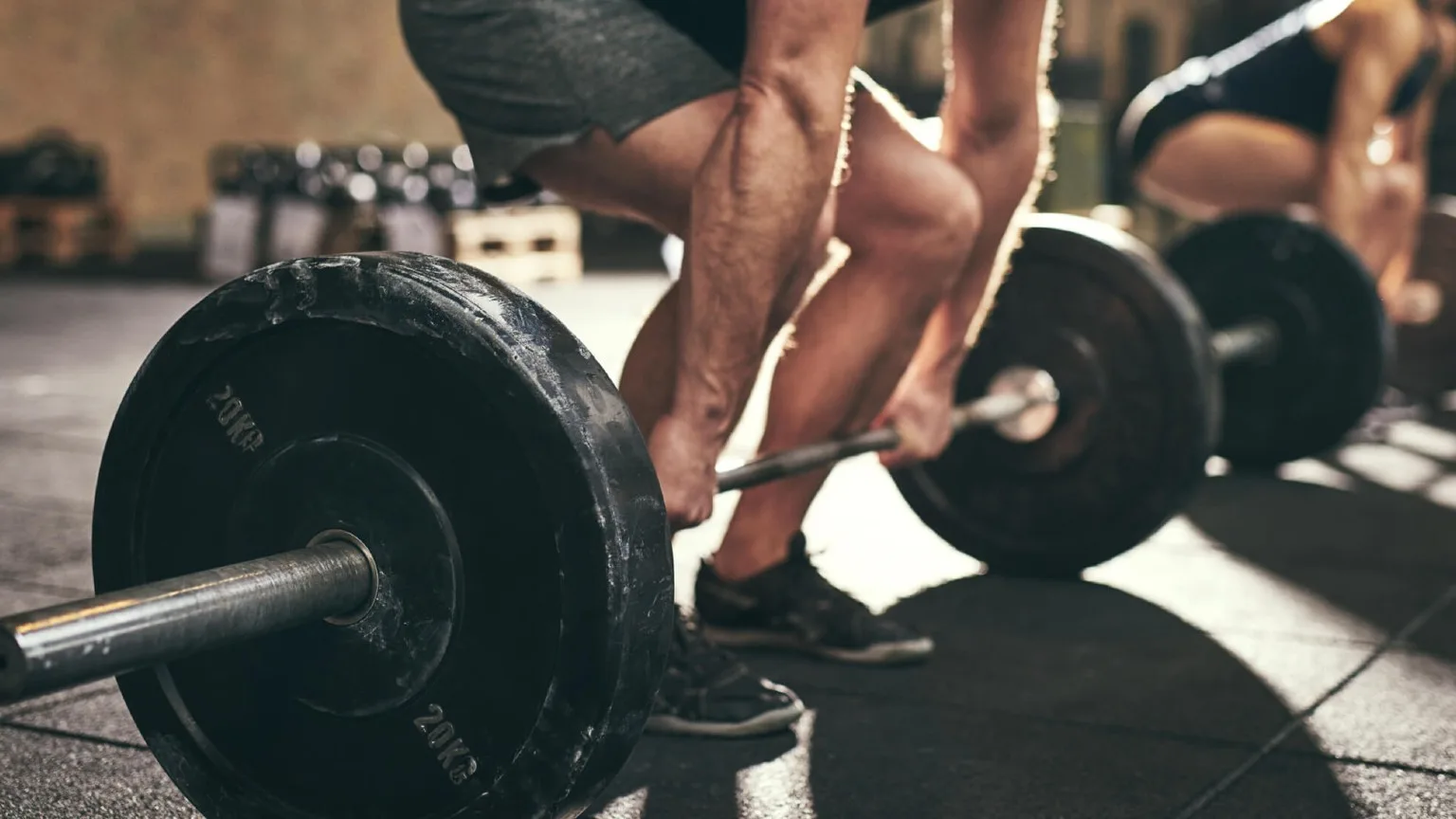 Image: Shutterstock A man lifting weights at a gym