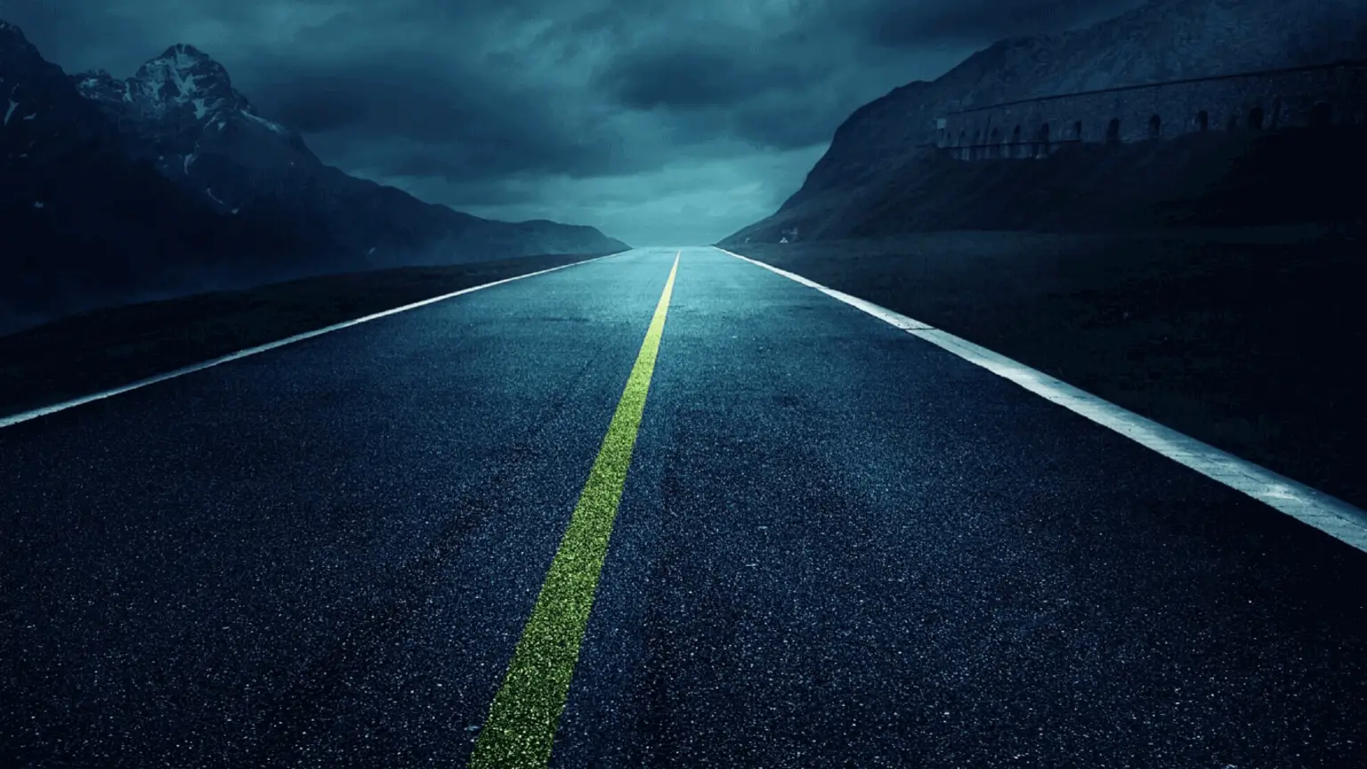Image: Shutterstock Open road in the mountains on a cloudy day