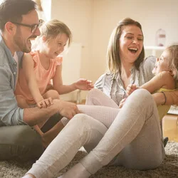 Image: Getty Images Family smiling at each other