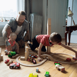 Image: Getty Images Father and children playing with wood blocks and toy train