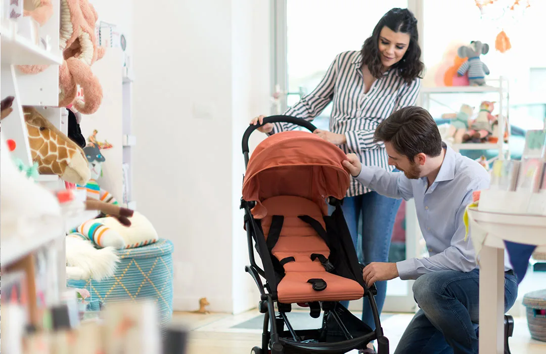 Image: Getty Images couple shopping for a pram in a baby store