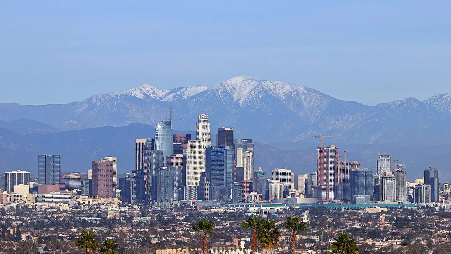 Image: Getty Images Skyline of Los Angeles with snowcapped moutain as background