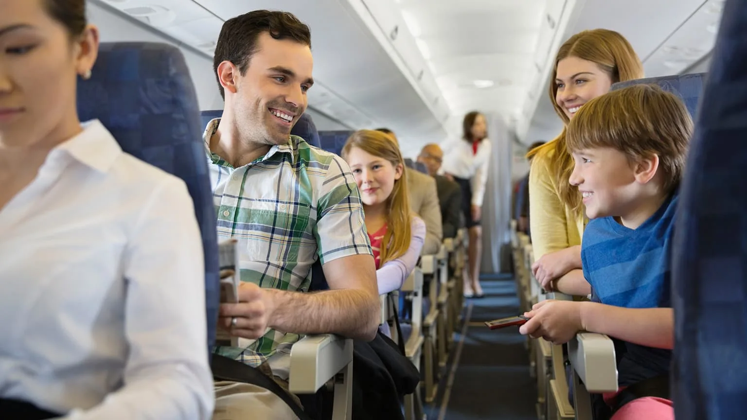 Image: Getty Images A young family seating by the aisle of an airplane