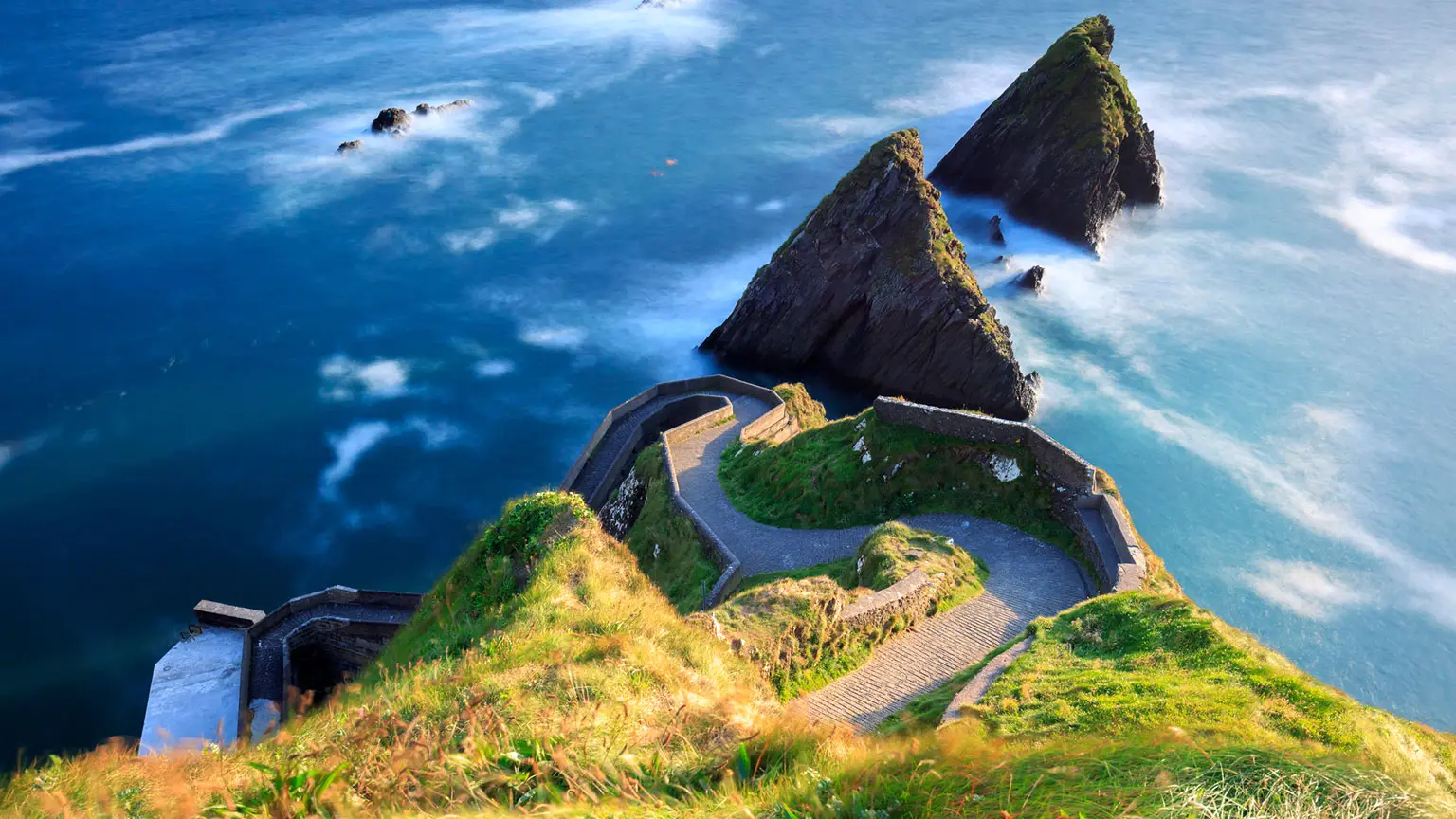 Image: Getty Images A winding road accessing the old pier along Dingle peninsula at sunset in Ireland